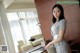 A woman standing in front of a desk in a hotel room.