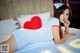 A woman in a nurse outfit laying on a bed.