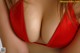 A close up of a woman in a red bikini.