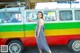 A woman standing in front of a colorful van.