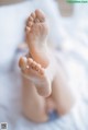 A close up of a baby's feet on a bed.